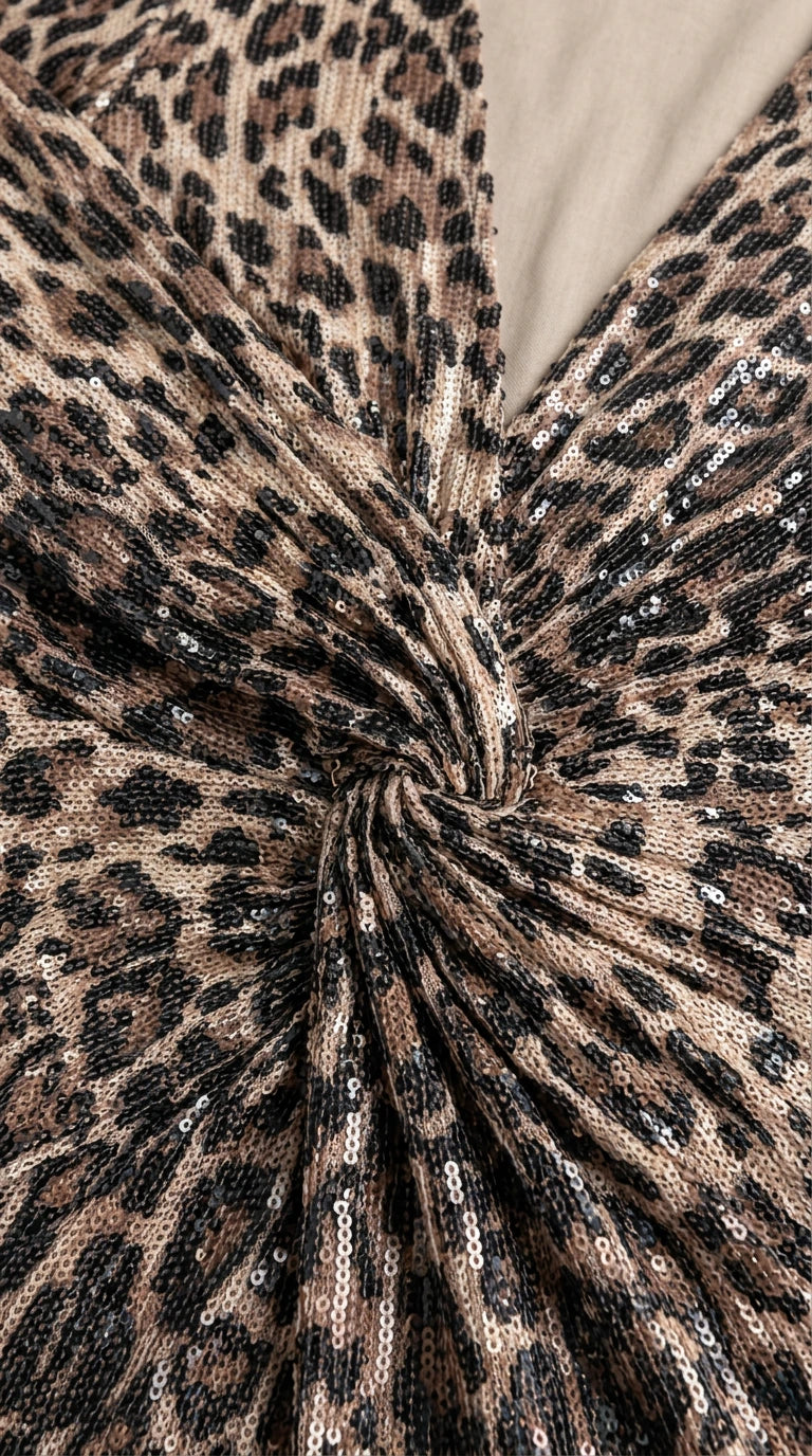 Close-up detail of leopard print fabric with sequin embellishment and center twist