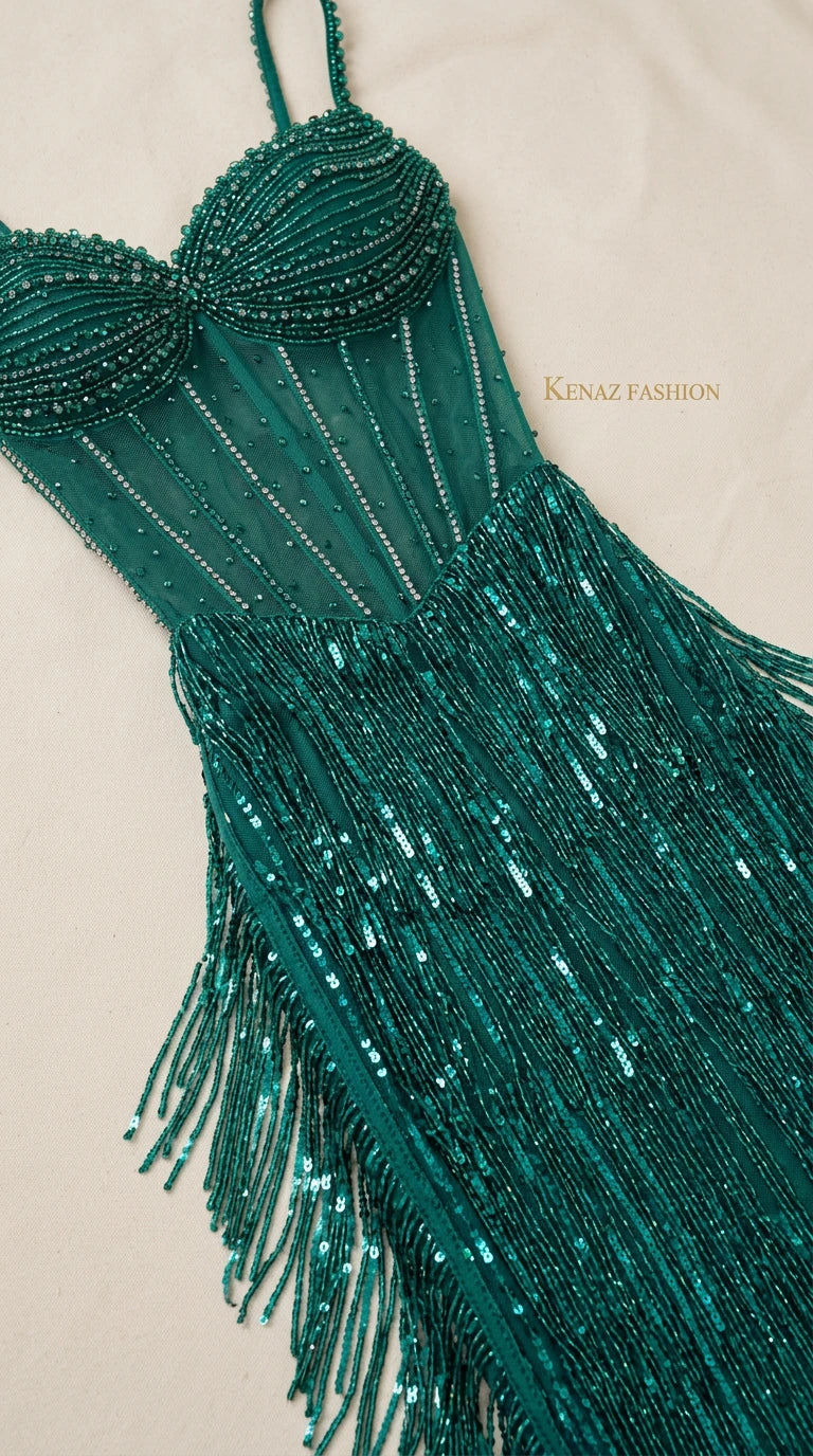 Close-up detail of the hand-beaded bodice and fringe craftsmanship on the Emerald Green gown