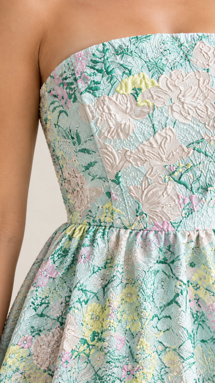 Close-up detail of textured floral jacquard fabric and strapless bodice