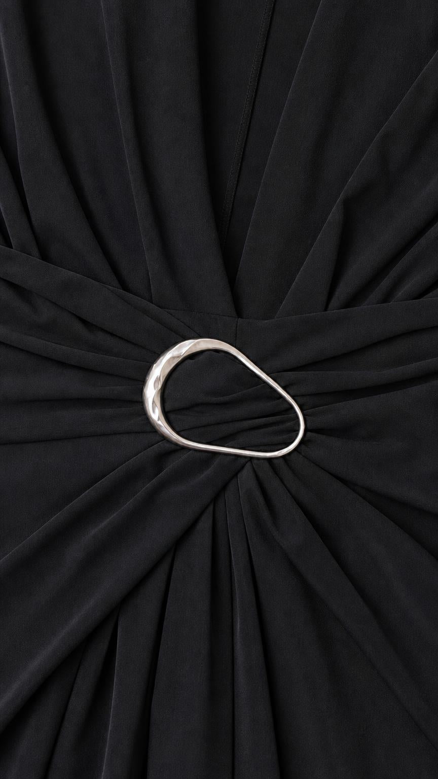 Close-up detail of metal ring waist accent on black dress