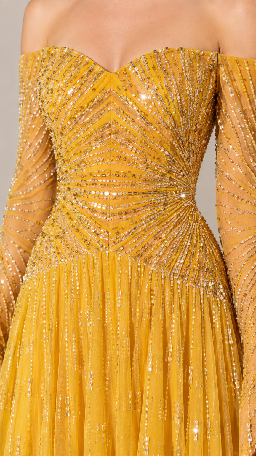 Close-up detail of sweetheart neckline and radiating sequin embroidery on bodice