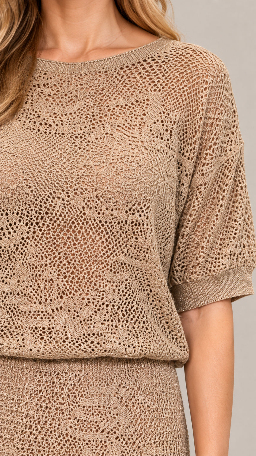 Close-up detail of textured crochet open-knit fabric and boat neckline in beige