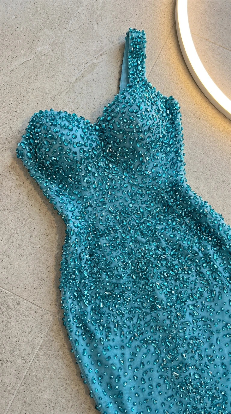 Close-up of teal bodice showing dense crystal and bead embellishments