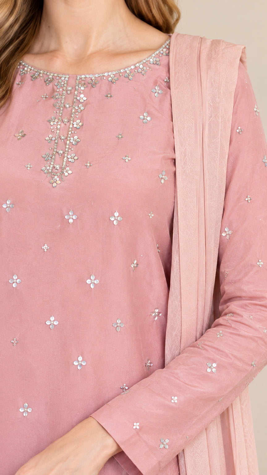 Close-up of beaded and sequin neckline embroidery and scalloped tunic detail in dusty rose