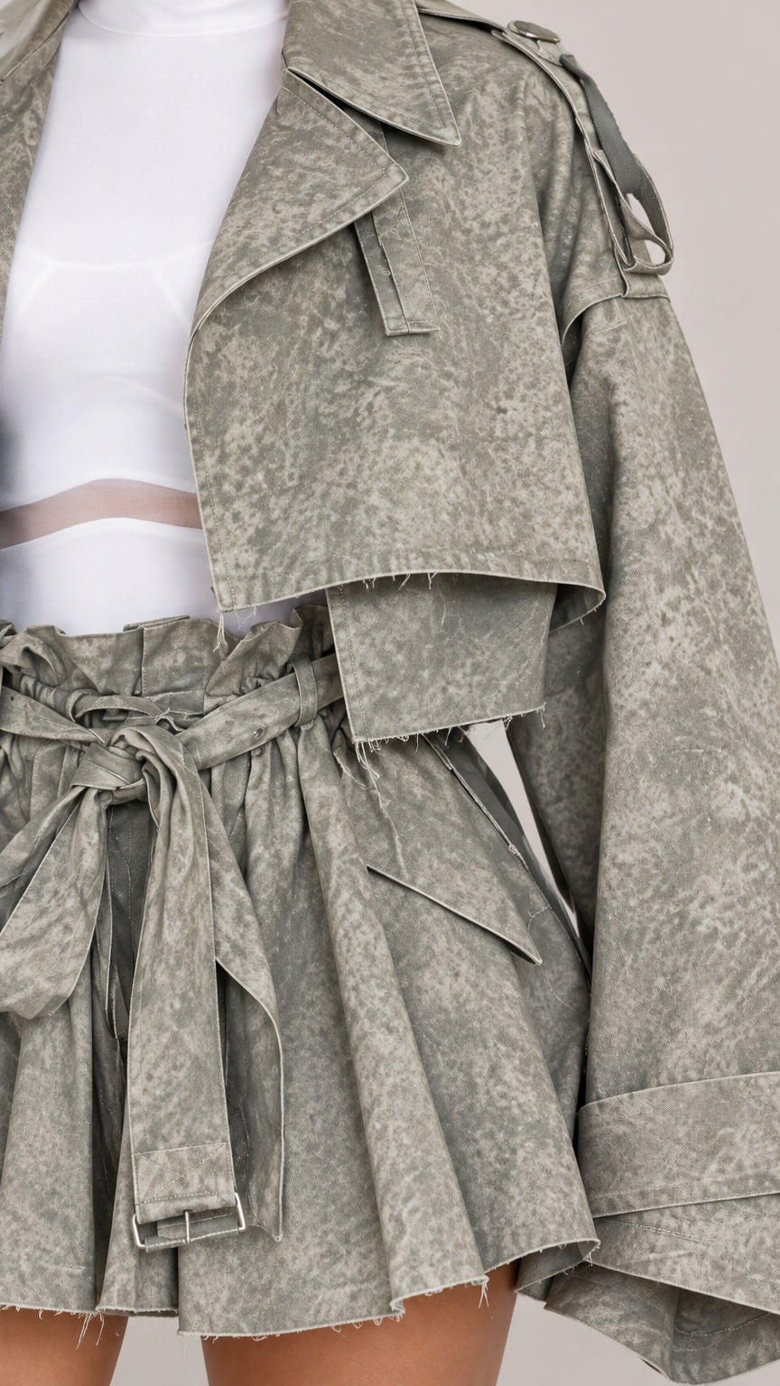 Close-up detail of Sage Green cropped trench jacket lapels and belted paperbag shorts waist