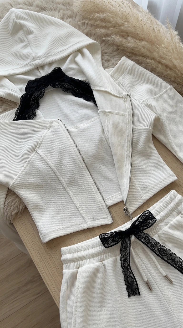 Close-up flat lay of white hoodie with lace trim and corset seams