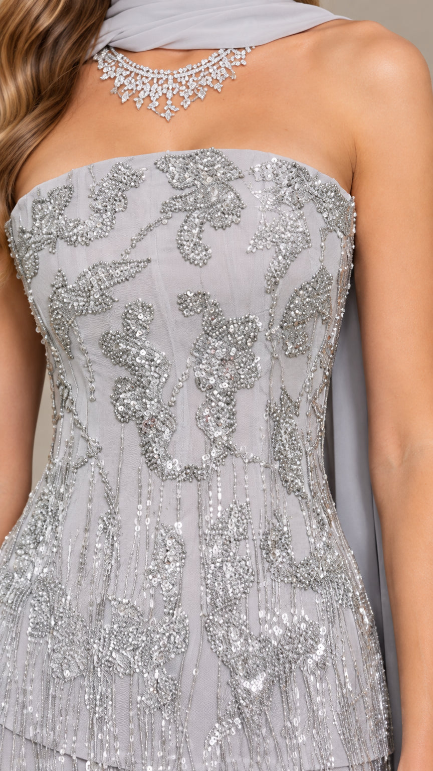 Close-up of intricate floral sequin and bead embellishment on strapless bodice