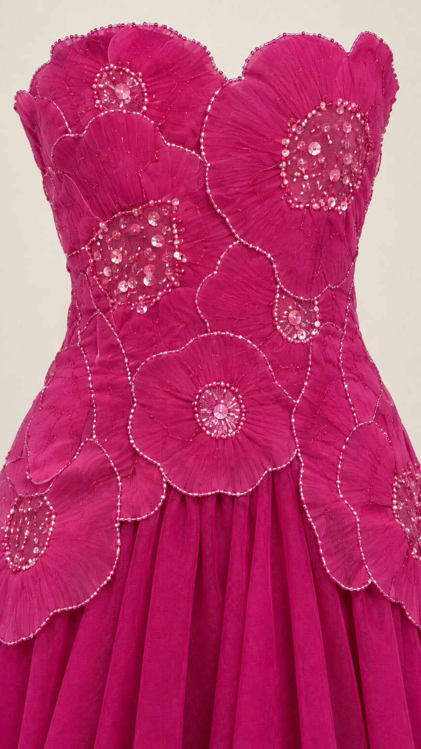 Close-up detail of beaded 3D petal embellishments on magenta dress bodice