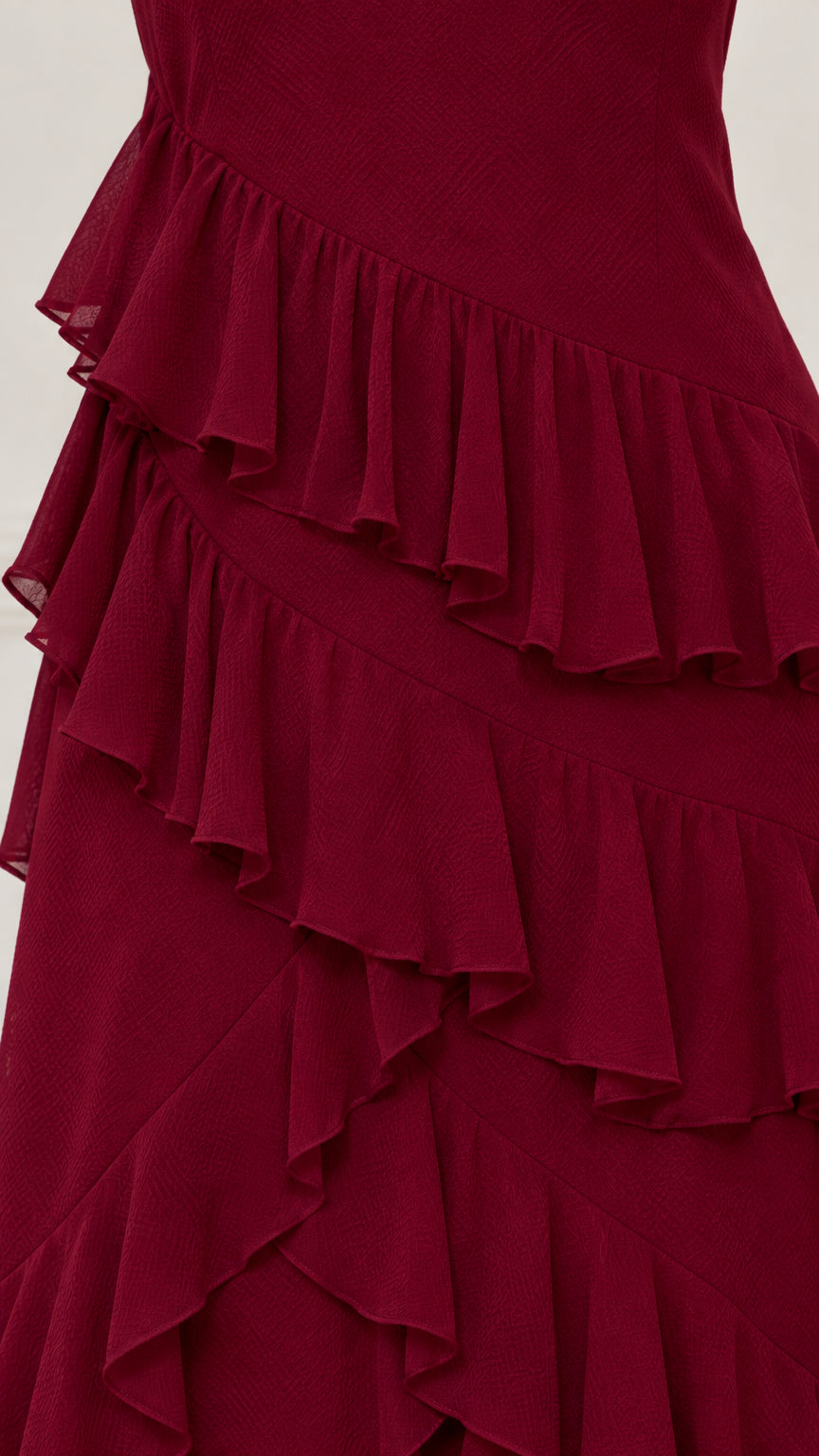 Close-up detail of tiered chiffon ruffles in burgundy