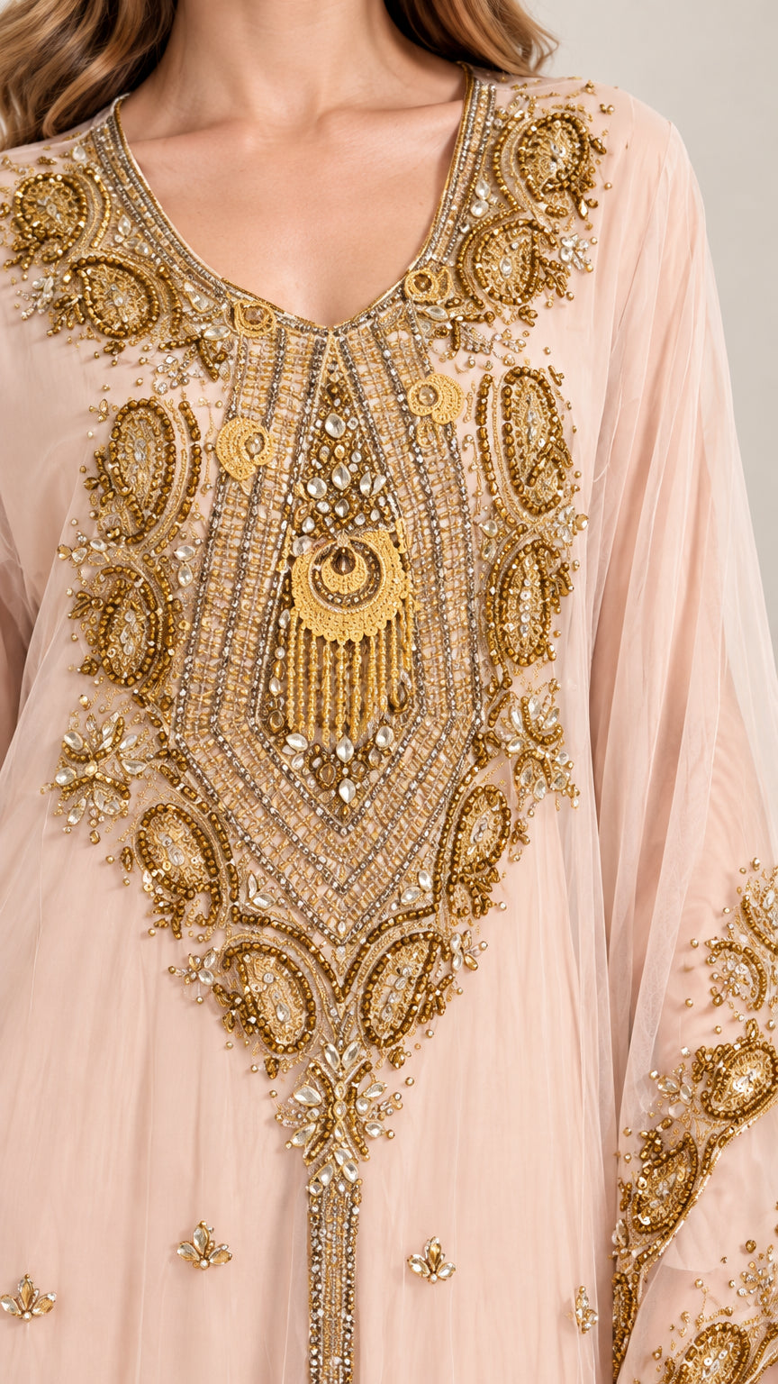 Close up of gold metallic embroidery and beaded detailing on kaftan bodice