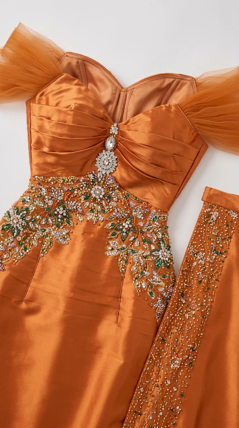 Close-up detail of sweetheart neckline and crystal beaded embroidery on orange gown