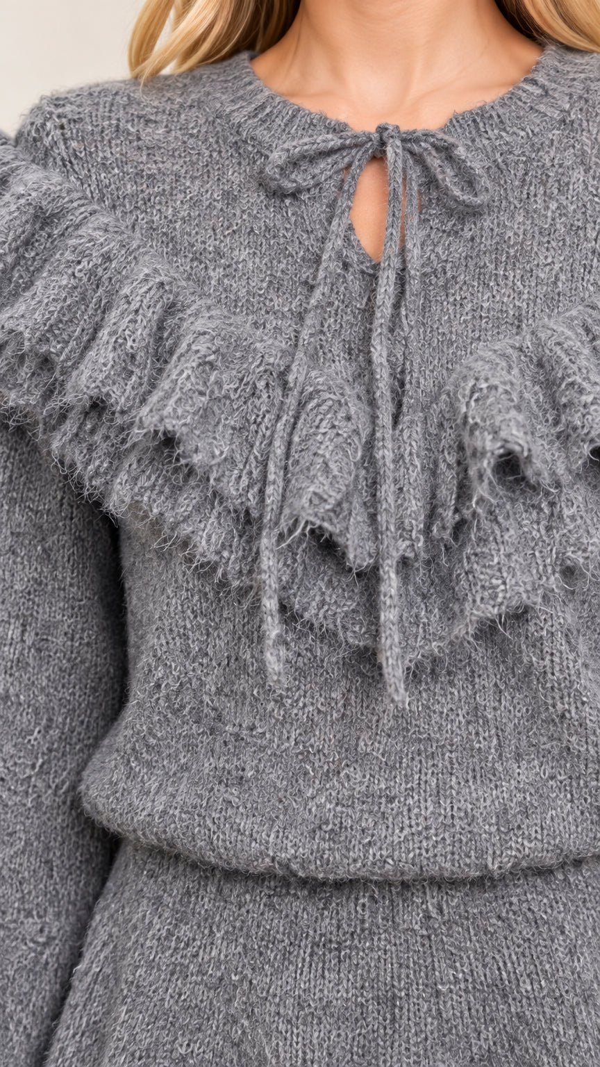 Close-up detail of Heather Grey fuzzy knit neckline, tie bow, and tiered ruffles