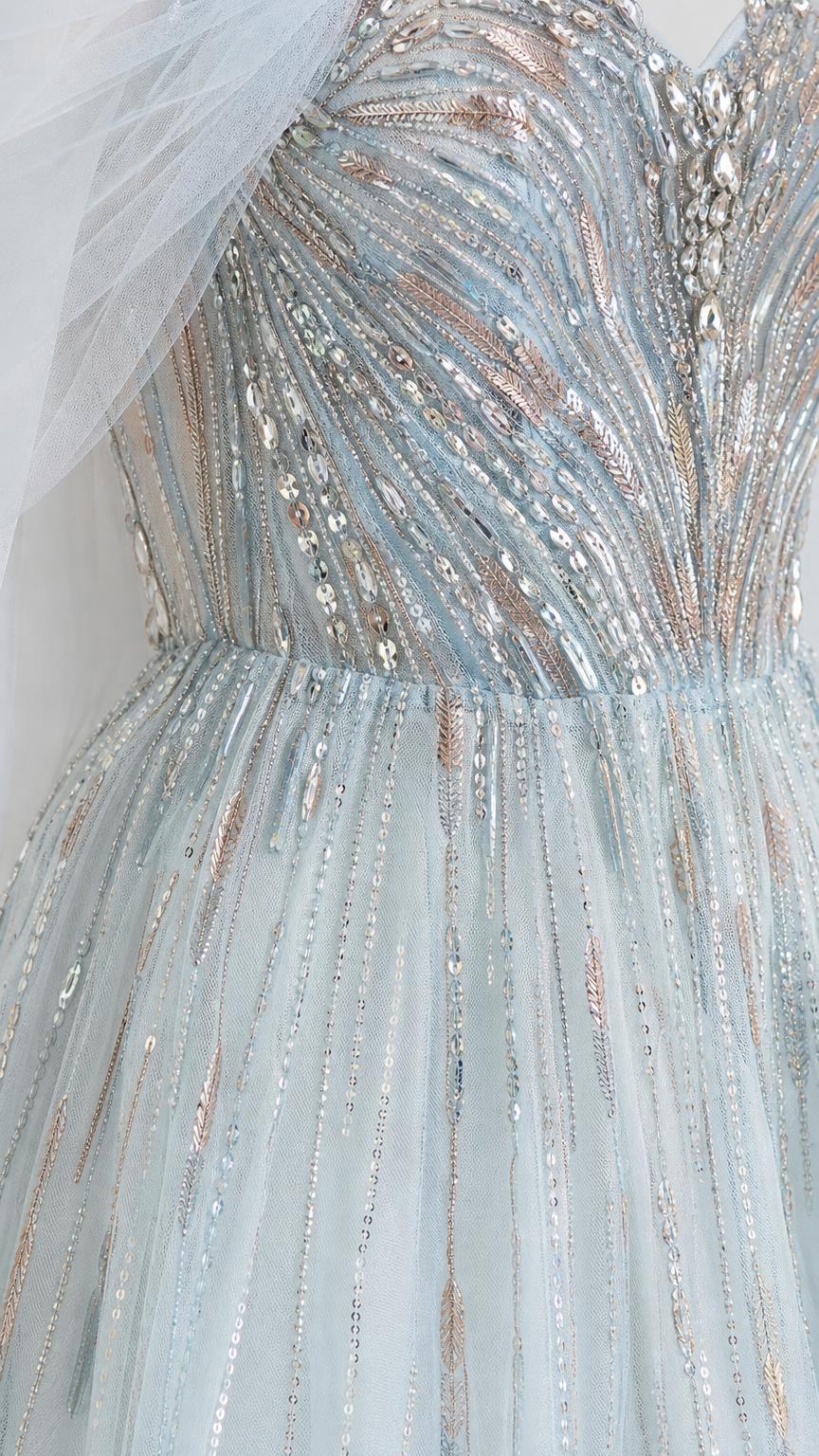 Close-up of sparkling bead and sequin embroidery on light blue dress