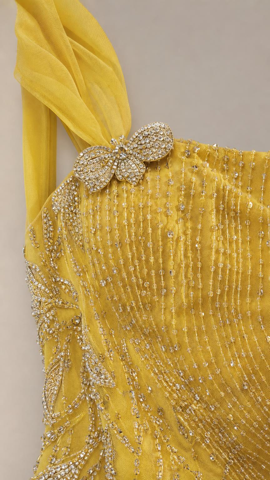 Close-up of crystal embellishment and beadwork on yellow dress