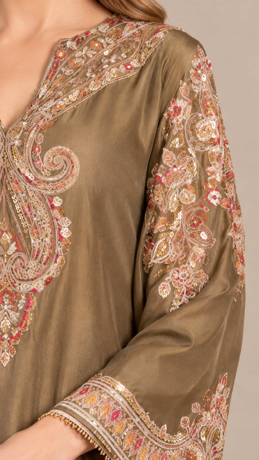 Close-up detail of paisley embroidery and sequin work on sleeve and neckline