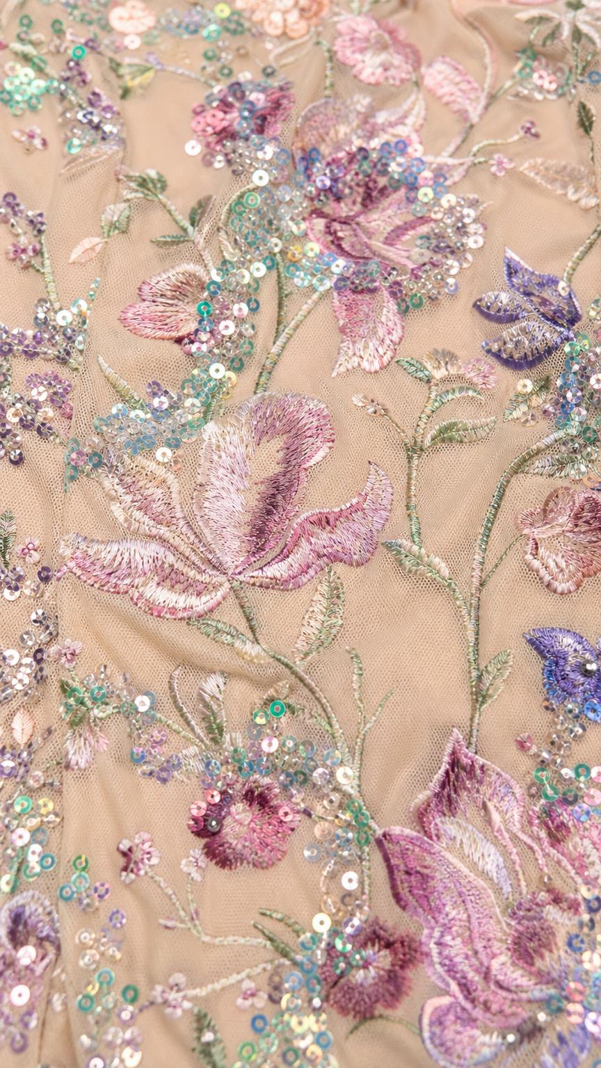 Close-up detail of floral embroidery and sequins on mesh fabric