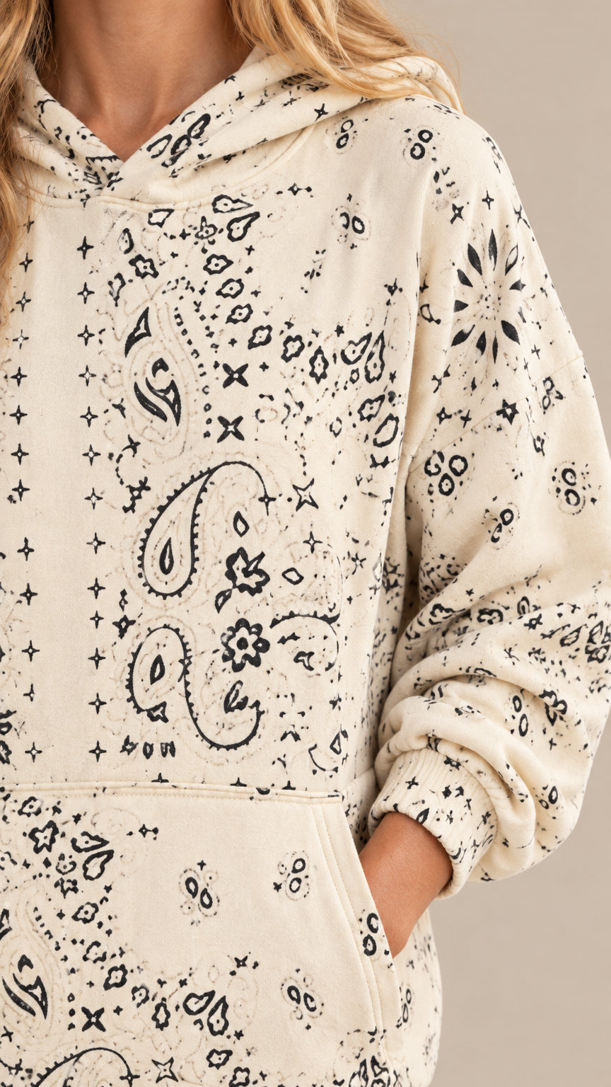 Close-up detail of cream bandana print hoodie showing the hood, pattern, and kangaroo pocket