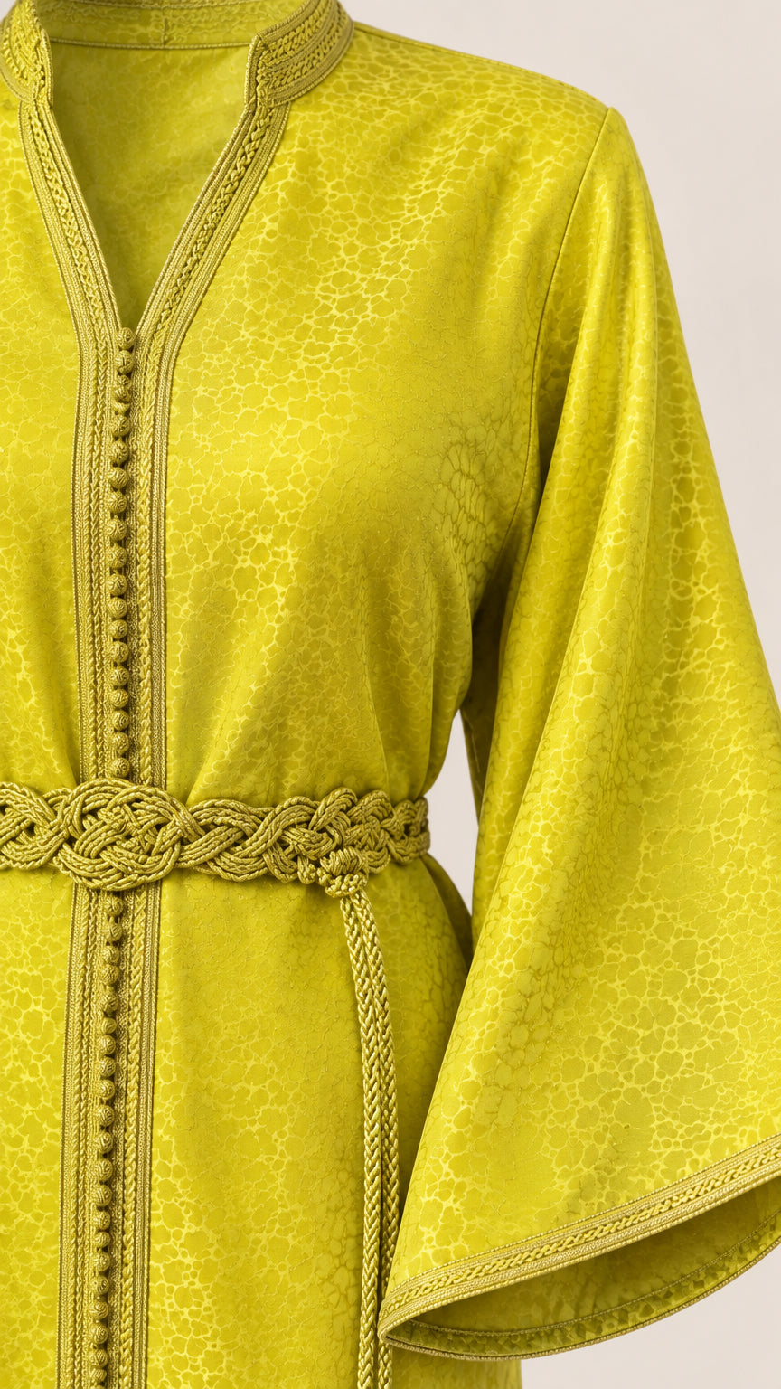 Close-up detail of Lime Green kaftan showing textured jacquard fabric, braided trim, and tassel belt