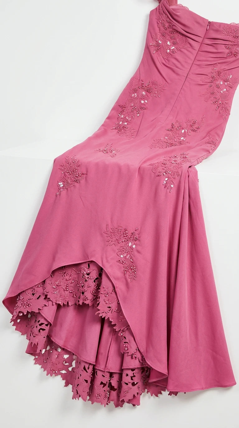 Close-up detail of embroidered fabric and scalloped lace hem
