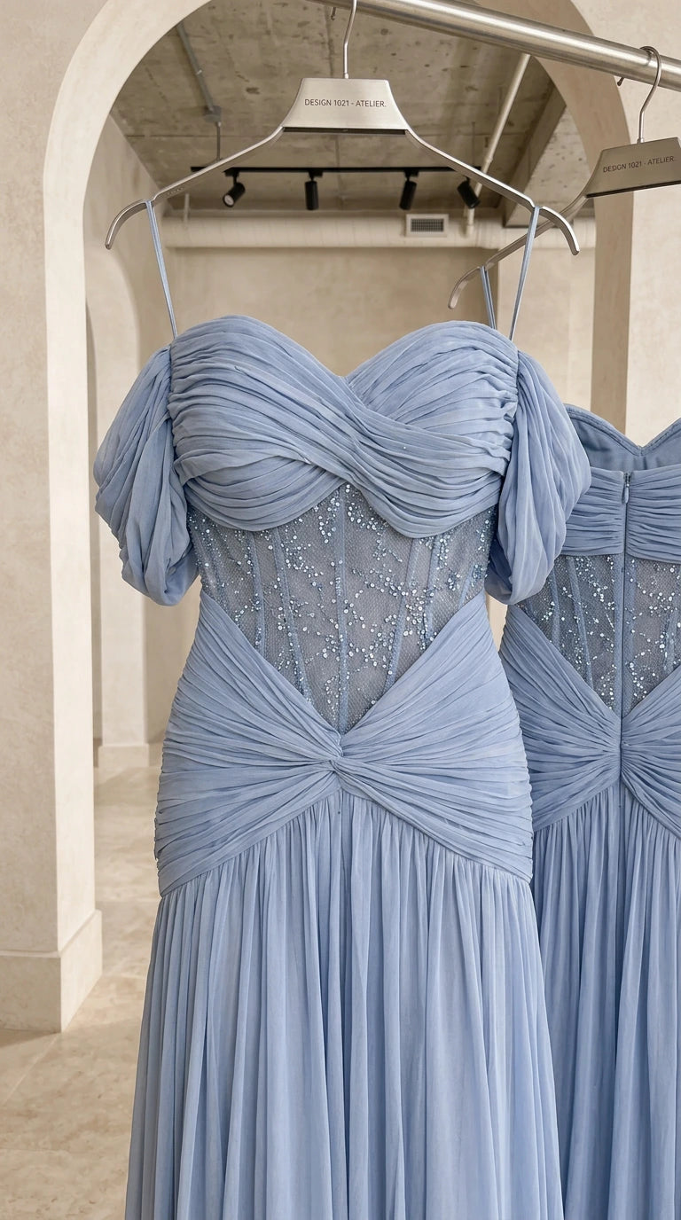 Close-up detail of embellished sheer corset bodice and draped chiffon fabric on hanger