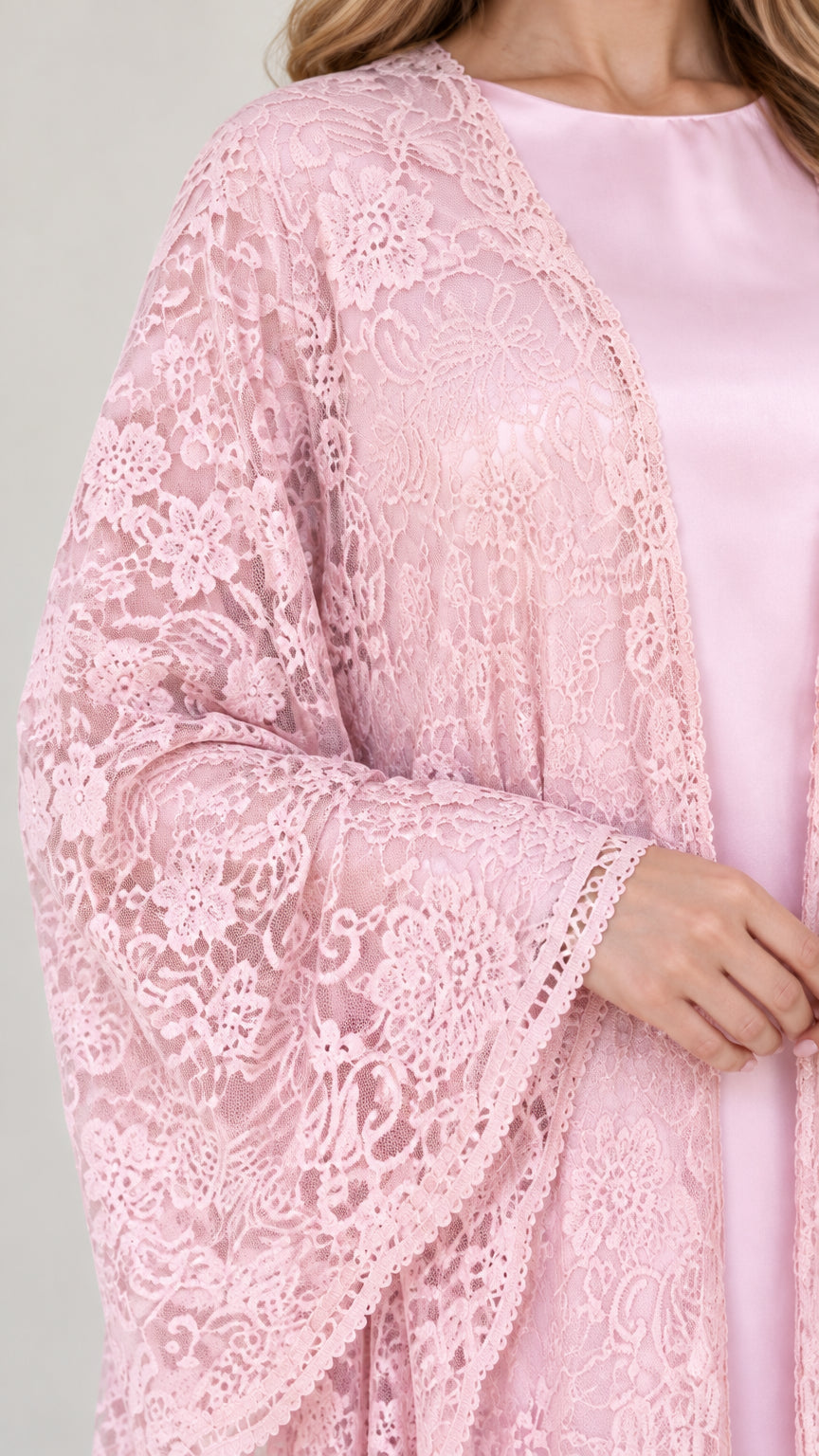 Close-up detail of sheer floral lace pattern and wide sleeve cuff on pink maxi dress
