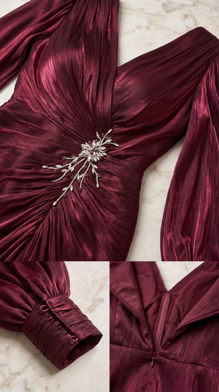 Close-up details of burgundy dress showing pleated bodice, crystal brooch, buttoned sleeve cuffs, and back zipper