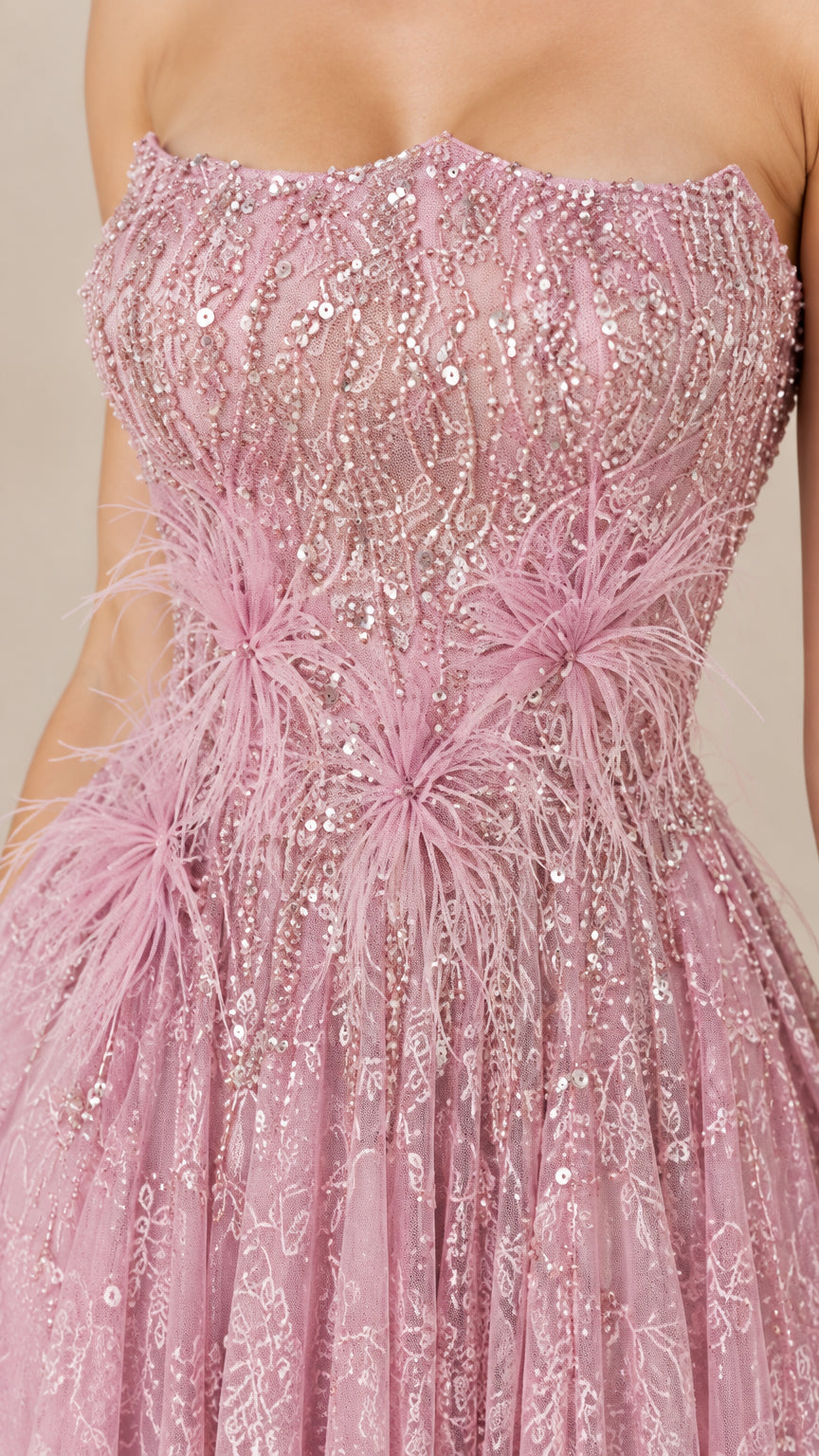 Close-up of sequin embroidery and feather embellishments on dusty rose bodice