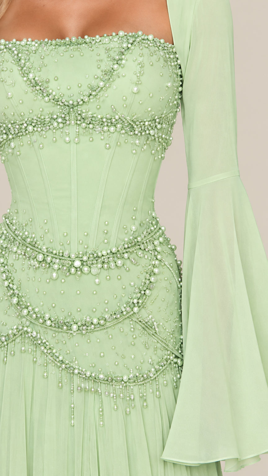 Close-up detail of mint green bodice with faux-pearl beadwork and boning