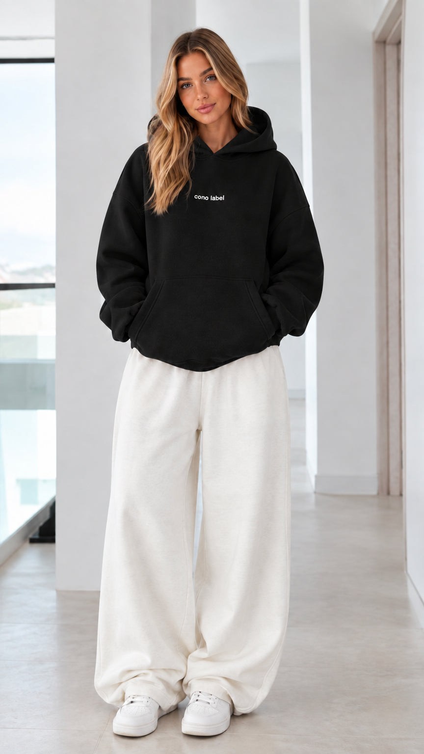 Women's oversized black pullover hoodie on model