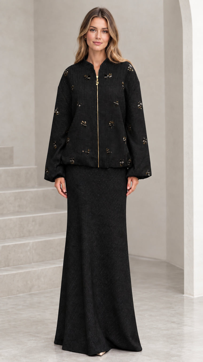 Full-length view of black beaded tweed jacket and maxi skirt two-piece set