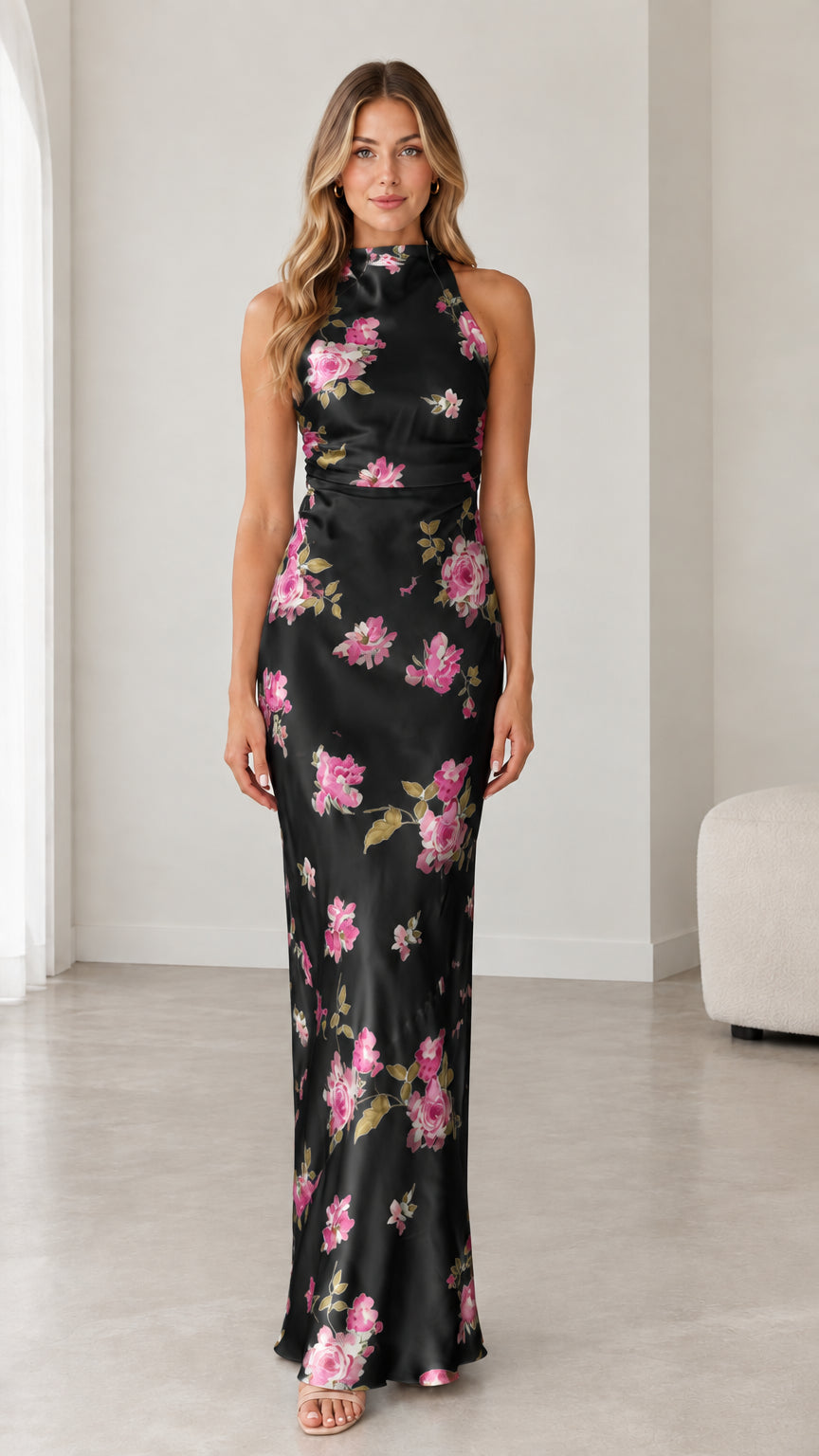 Model wearing black floral satin halter open back evening maxi dress