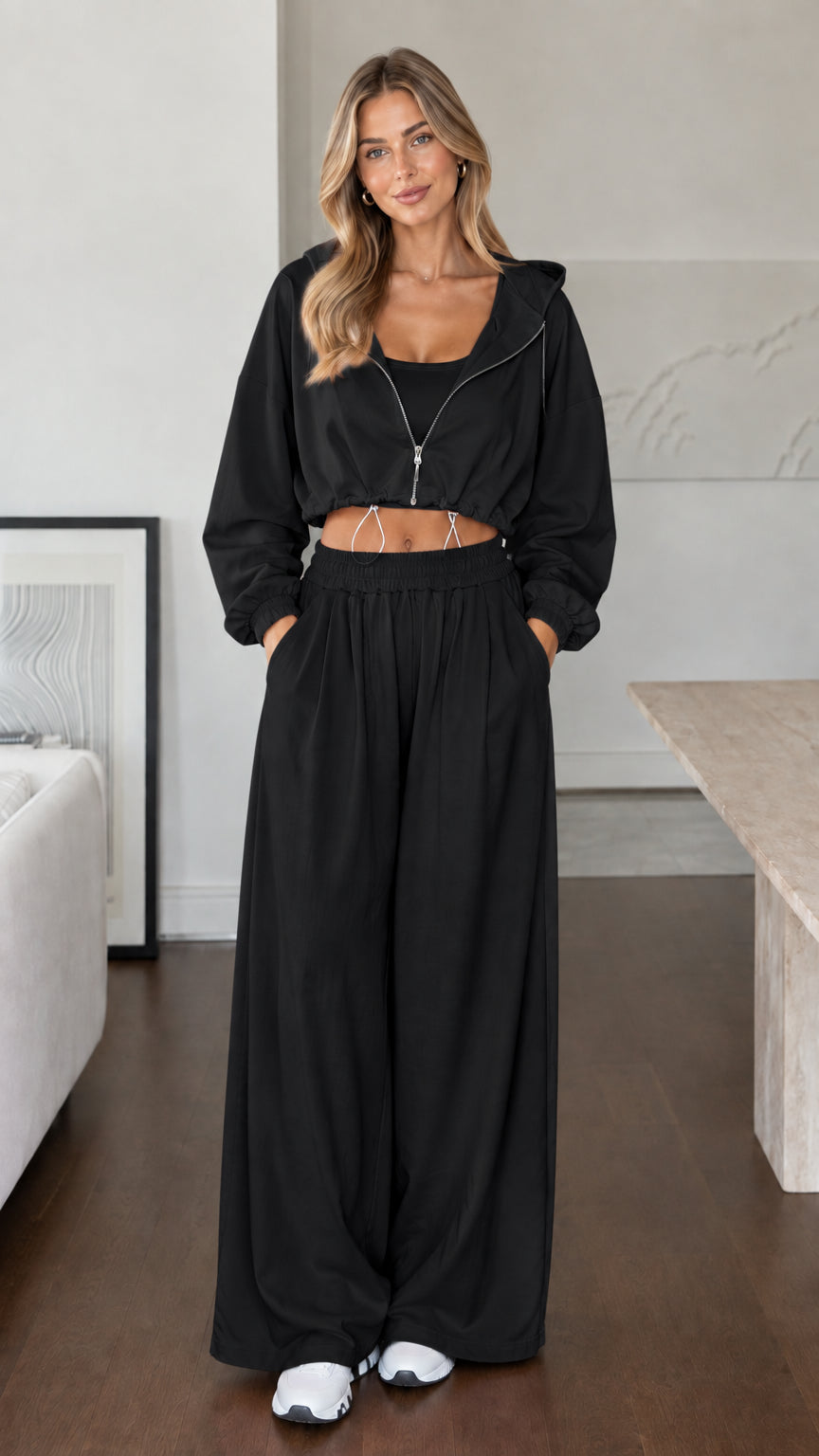 Model wearing classic black cropped hoodie and wide-leg lounge set