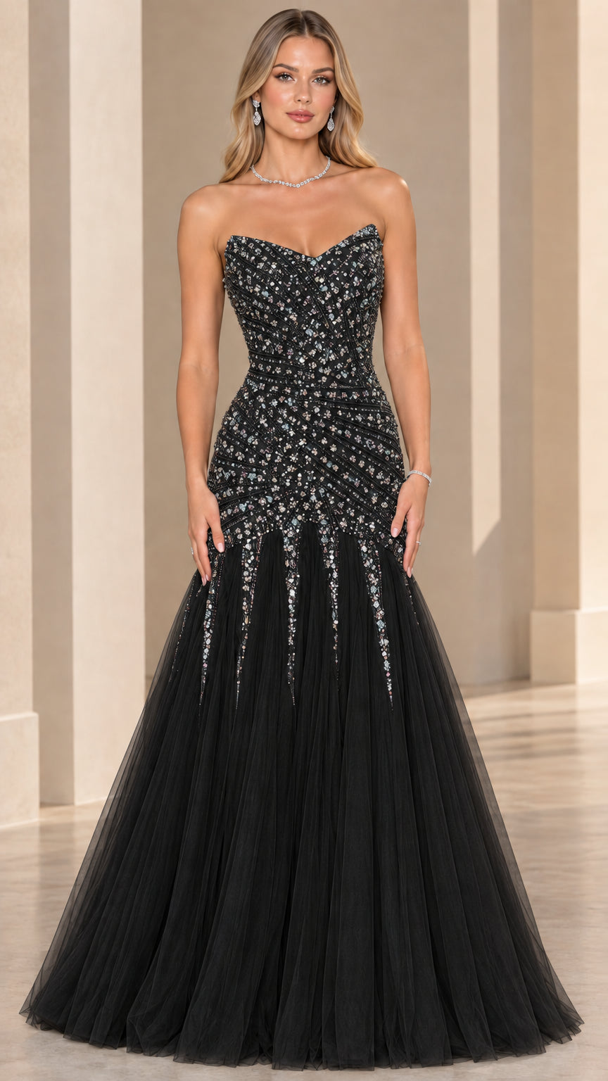 Front view of model wearing black strapless beaded mermaid formal gown