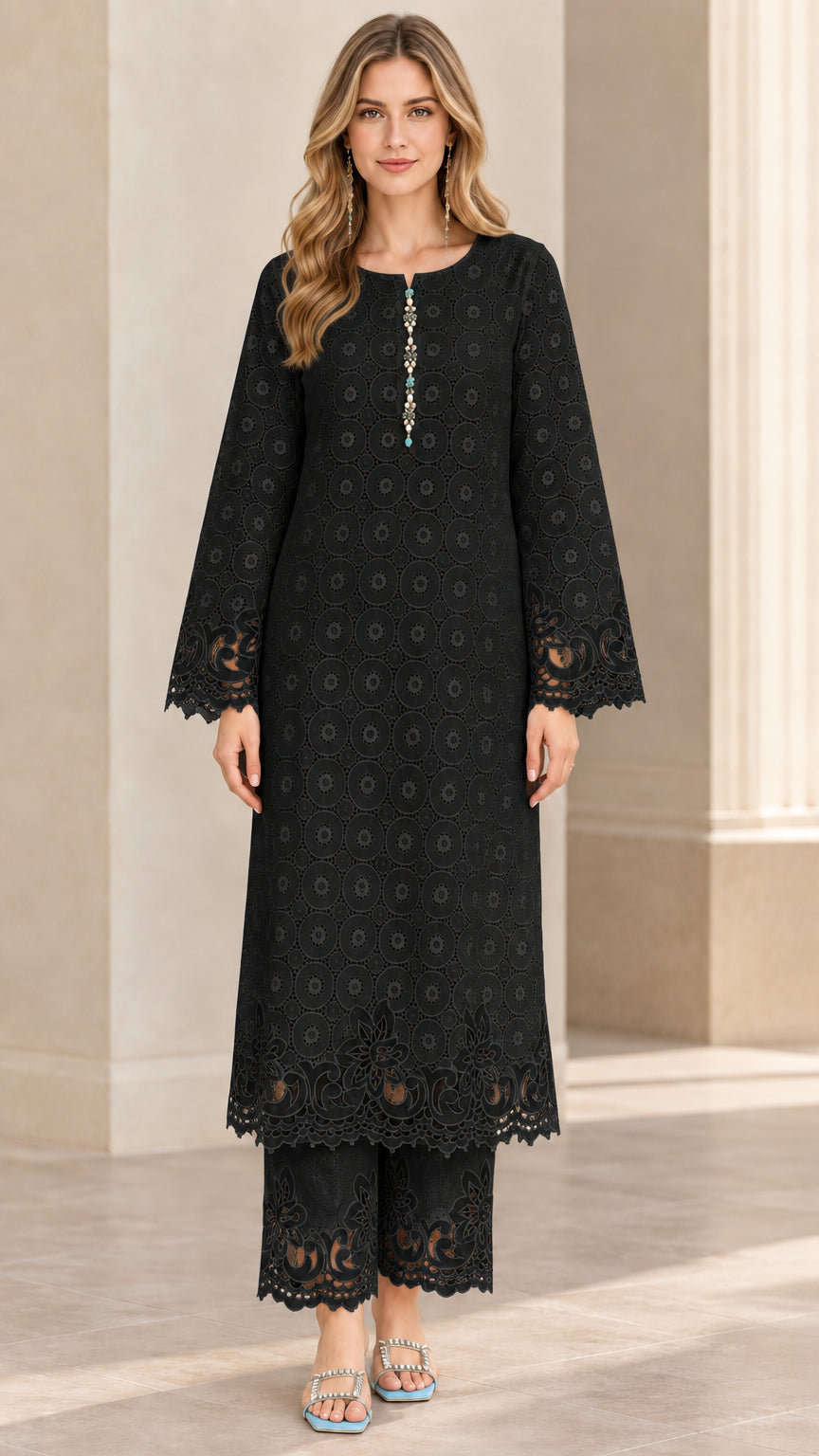 Front view of woman wearing black eyelet embroidered long tunic and matching trouser two-piece set