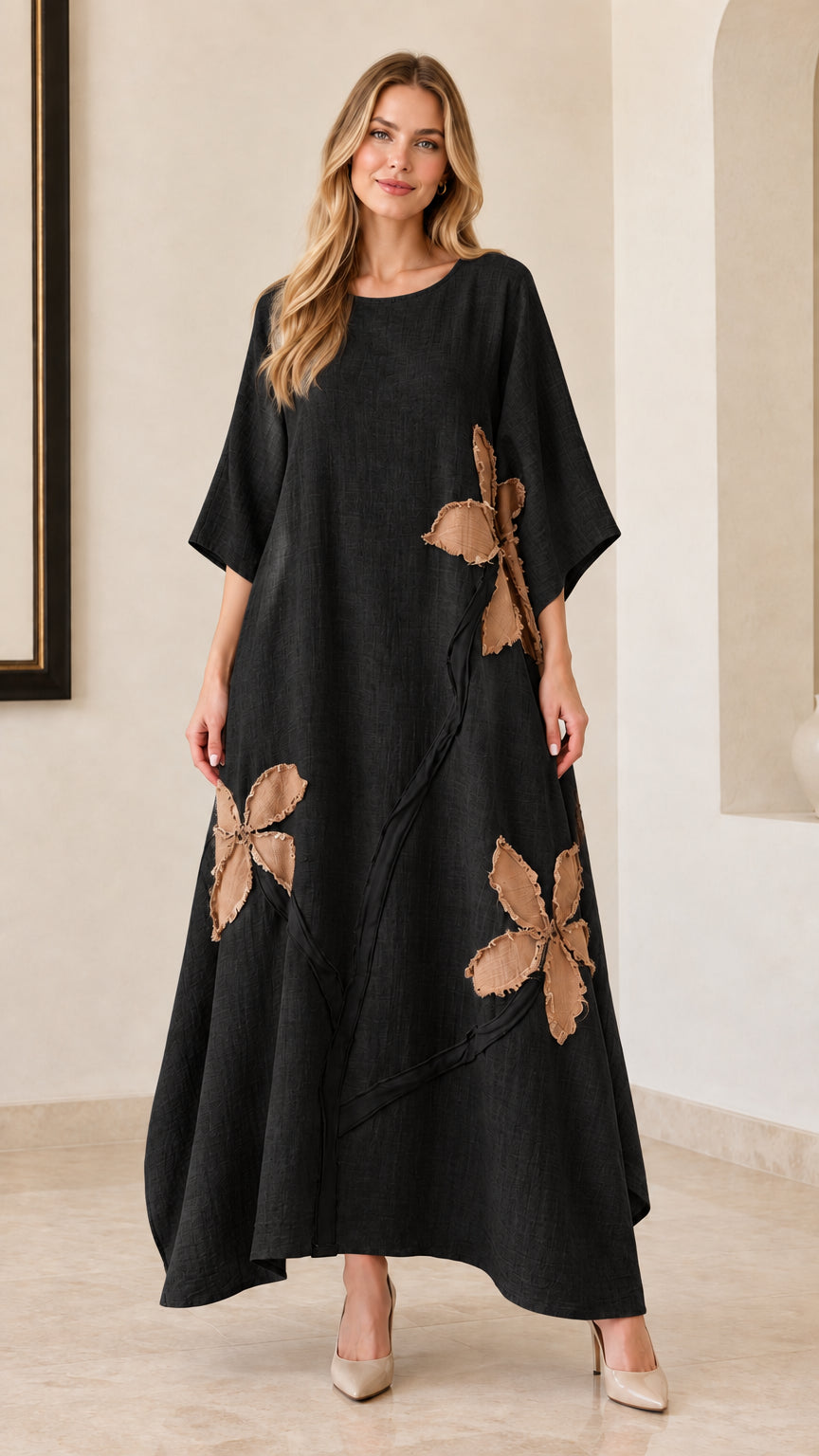 Woman wearing black floral appliqué relaxed maxi dress