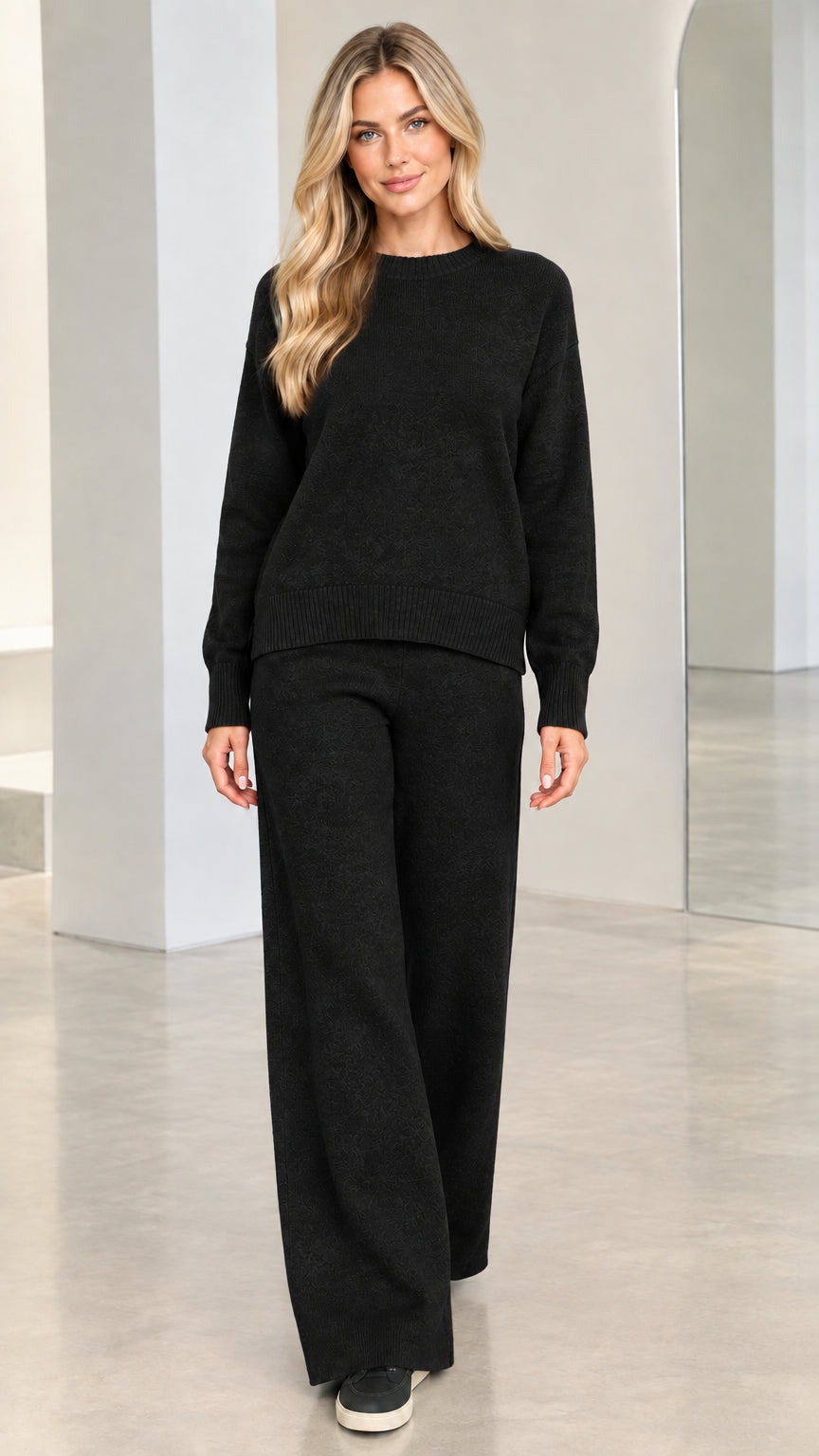 Model wearing black 2-piece knit sweater and wide-leg pants set