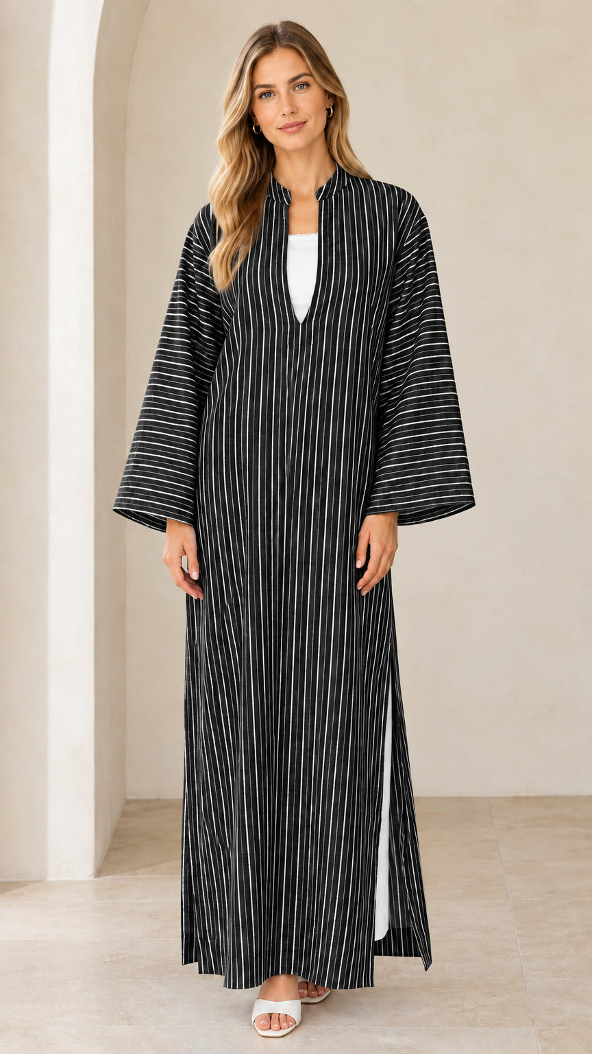 Woman wearing black vertical striped maxi kaftan dress