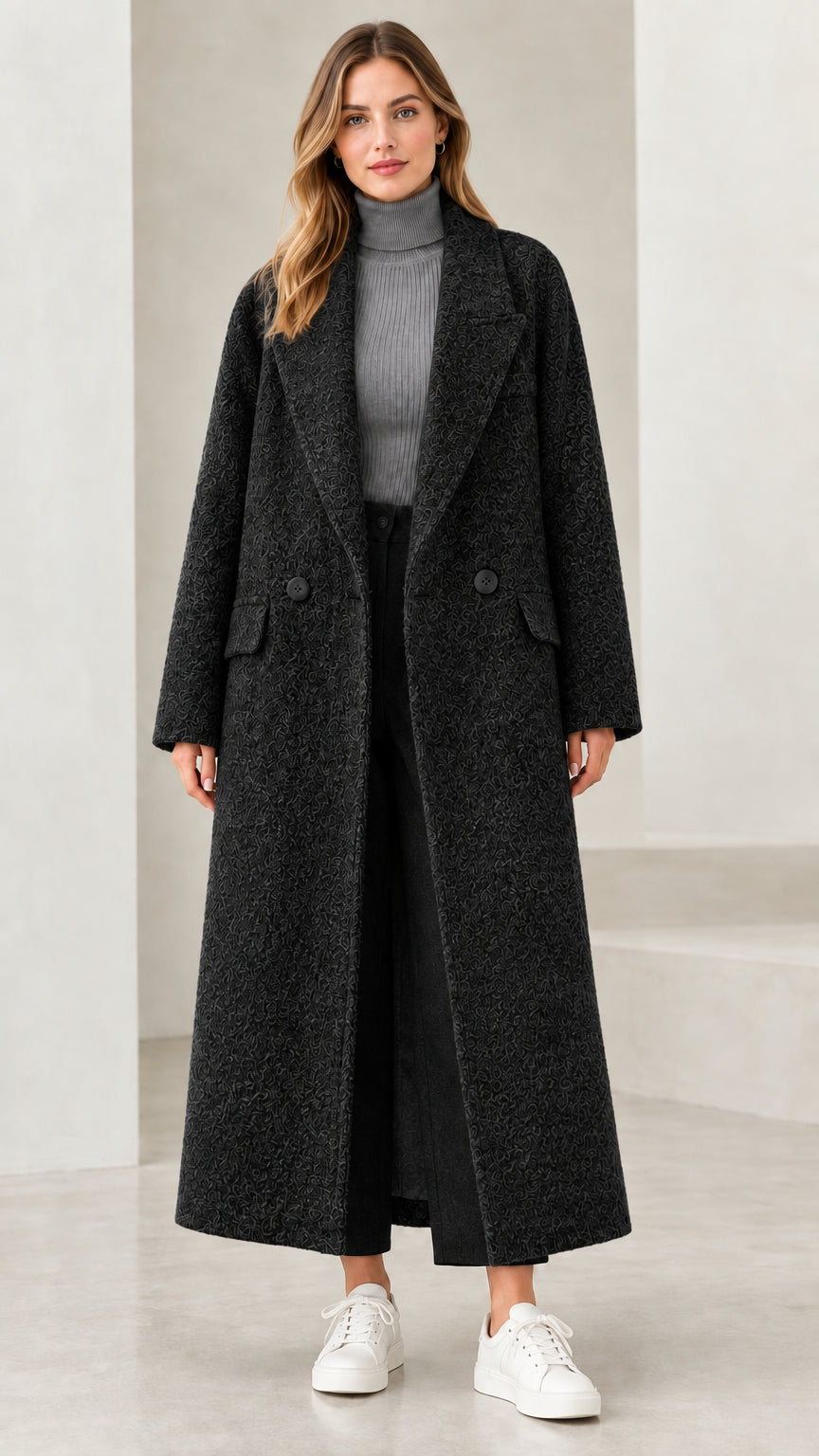 Front view of woman wearing black longline bouclé overcoat