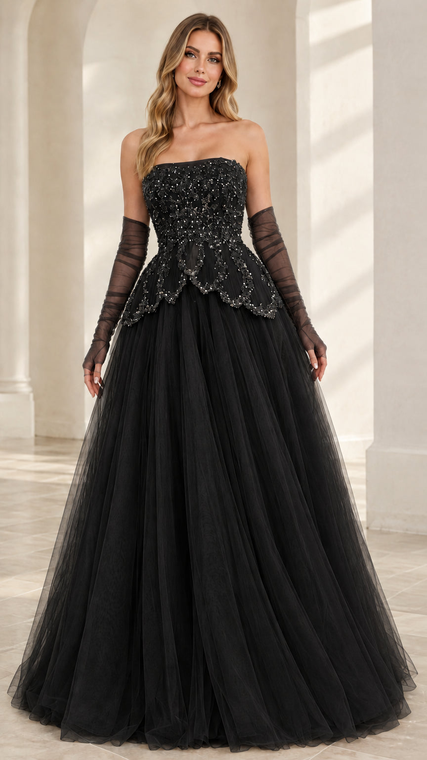 Front view of model wearing Black strapless beaded tulle ball gown with matching gloves