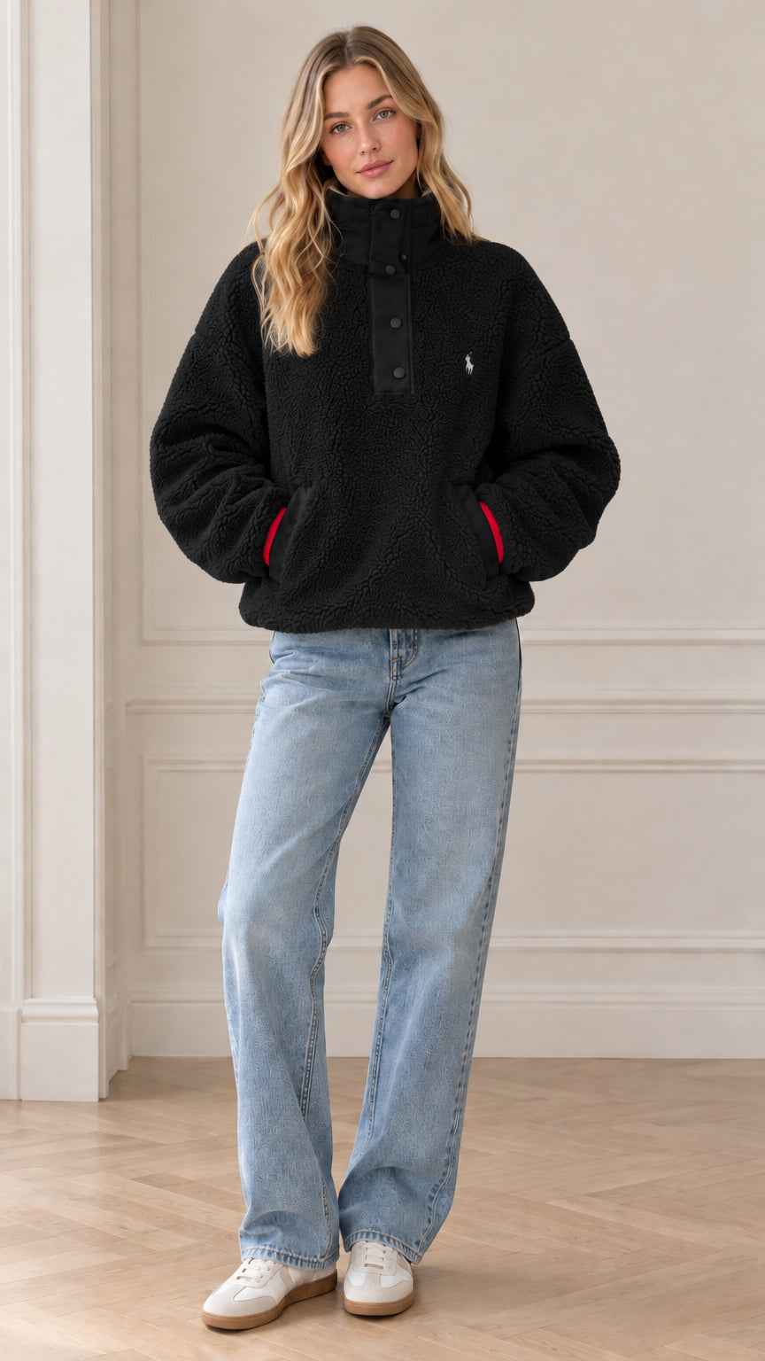 Front view of model wearing black sherpa fleece snap-neck pullover
