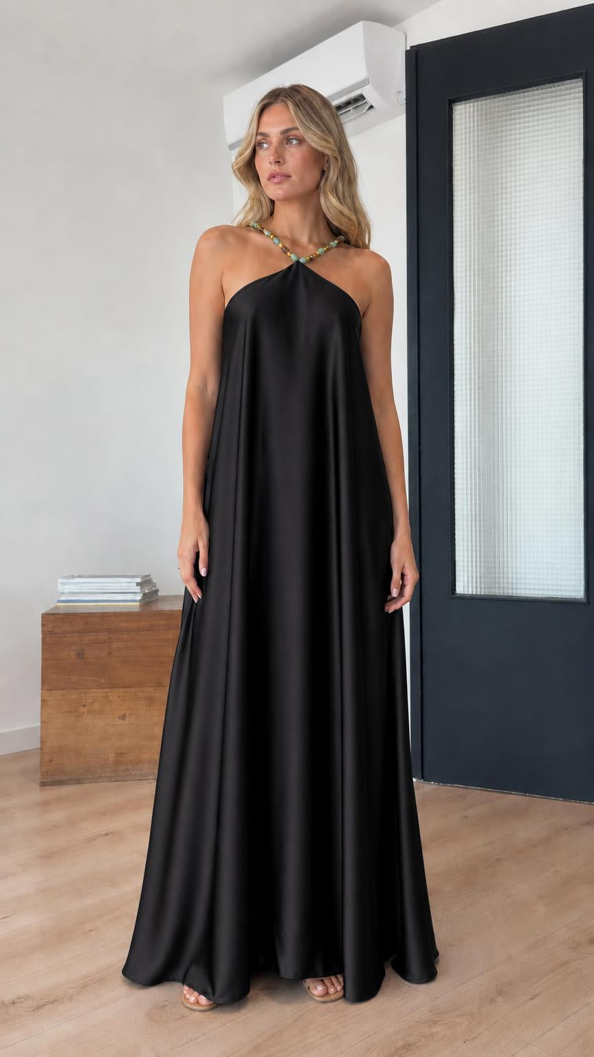 Model wearing black satin halter maxi dress