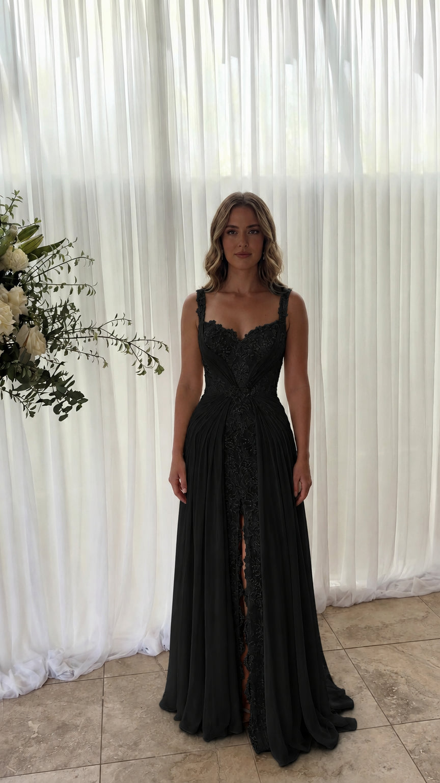 Front view of model wearing black lace inset pleated chiffon maxi dress