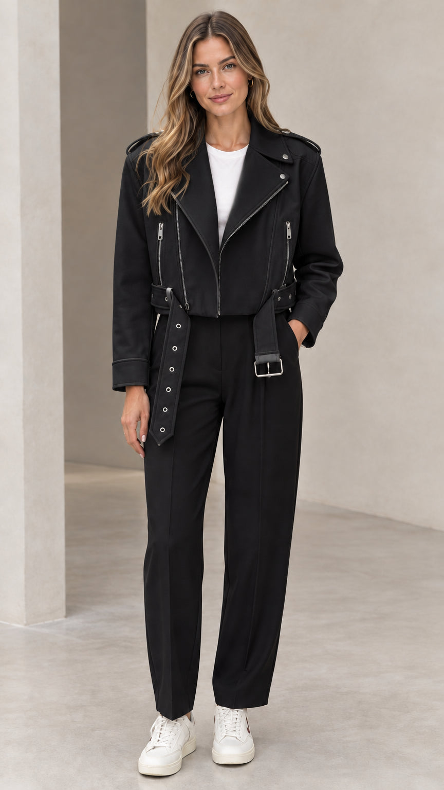 Front view of woman wearing black cropped faux leather moto biker jacket