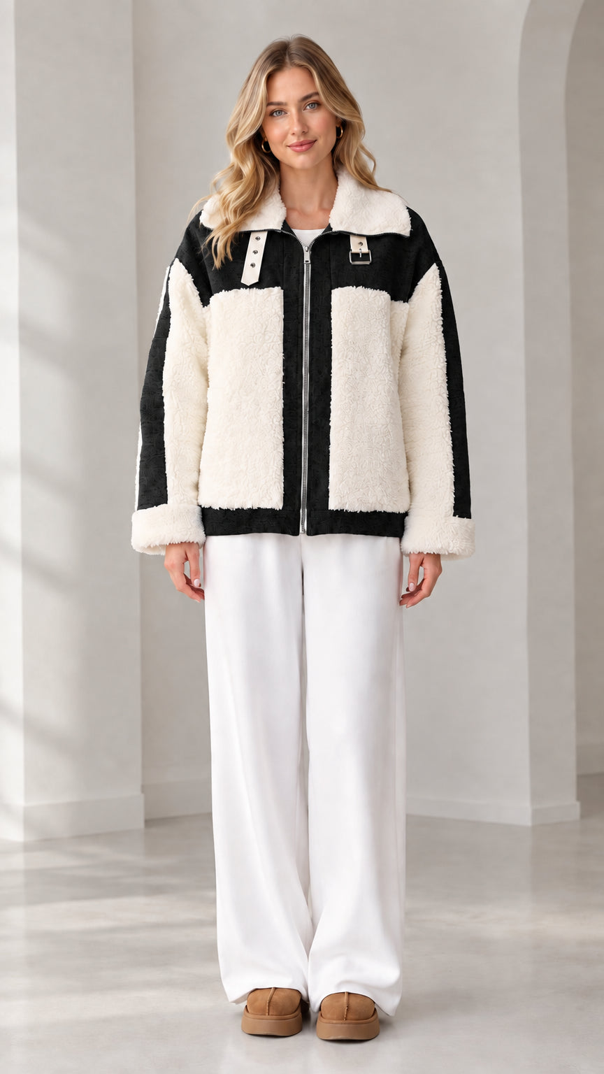 Front view of woman wearing black and cream colorblock sherpa fleece zip jacket