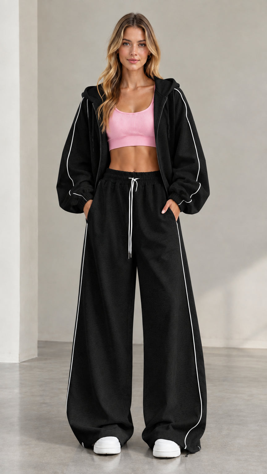 Model wearing Black two-piece tracksuit set with white contrast piping