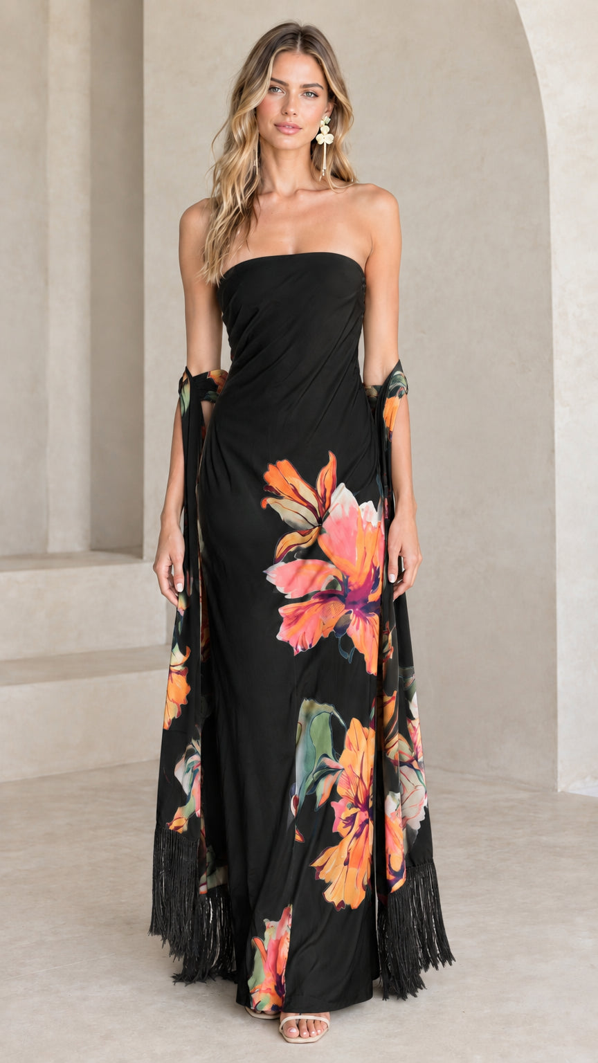 Black strapless maxi dress with vibrant floral print and matching fringe scarf