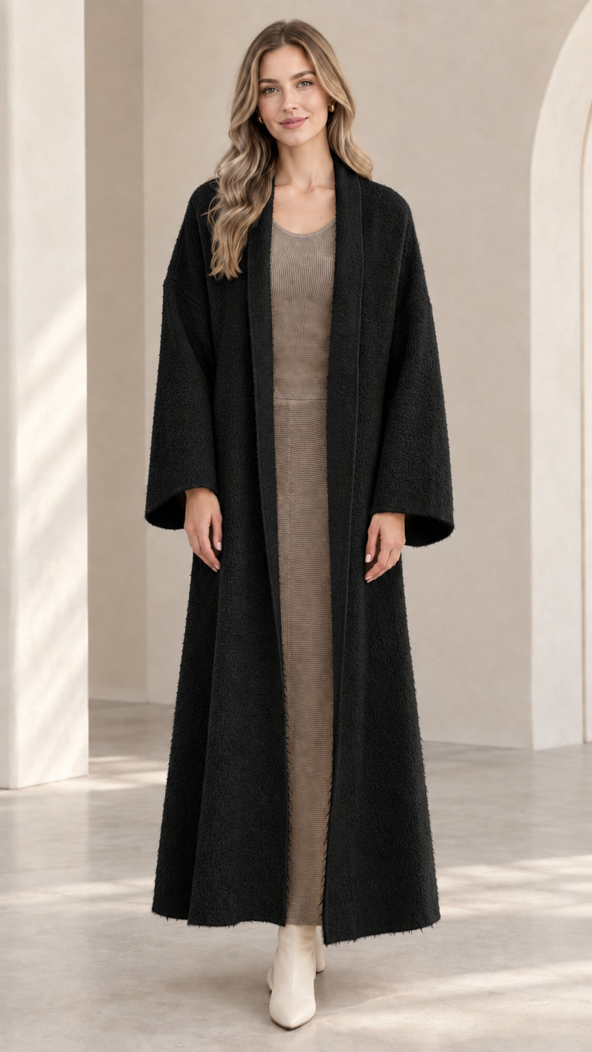 Front view of model wearing black textured maxi open-front duster coat