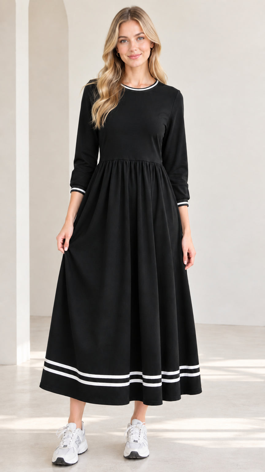Front view of model wearing black 3/4 sleeve maxi dress with white striped trim