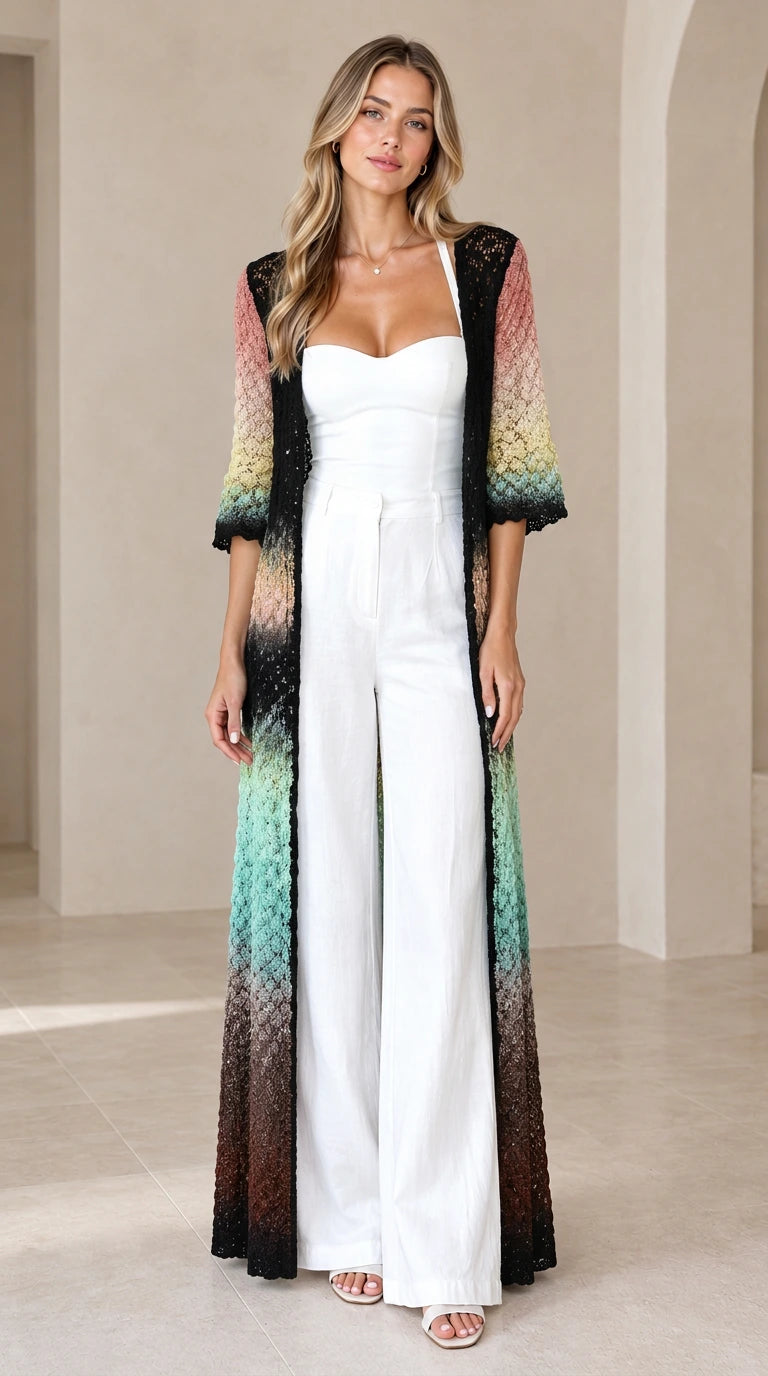 Front view of woman wearing Black Multi gradient crochet maxi duster cardigan over white jumpsuit