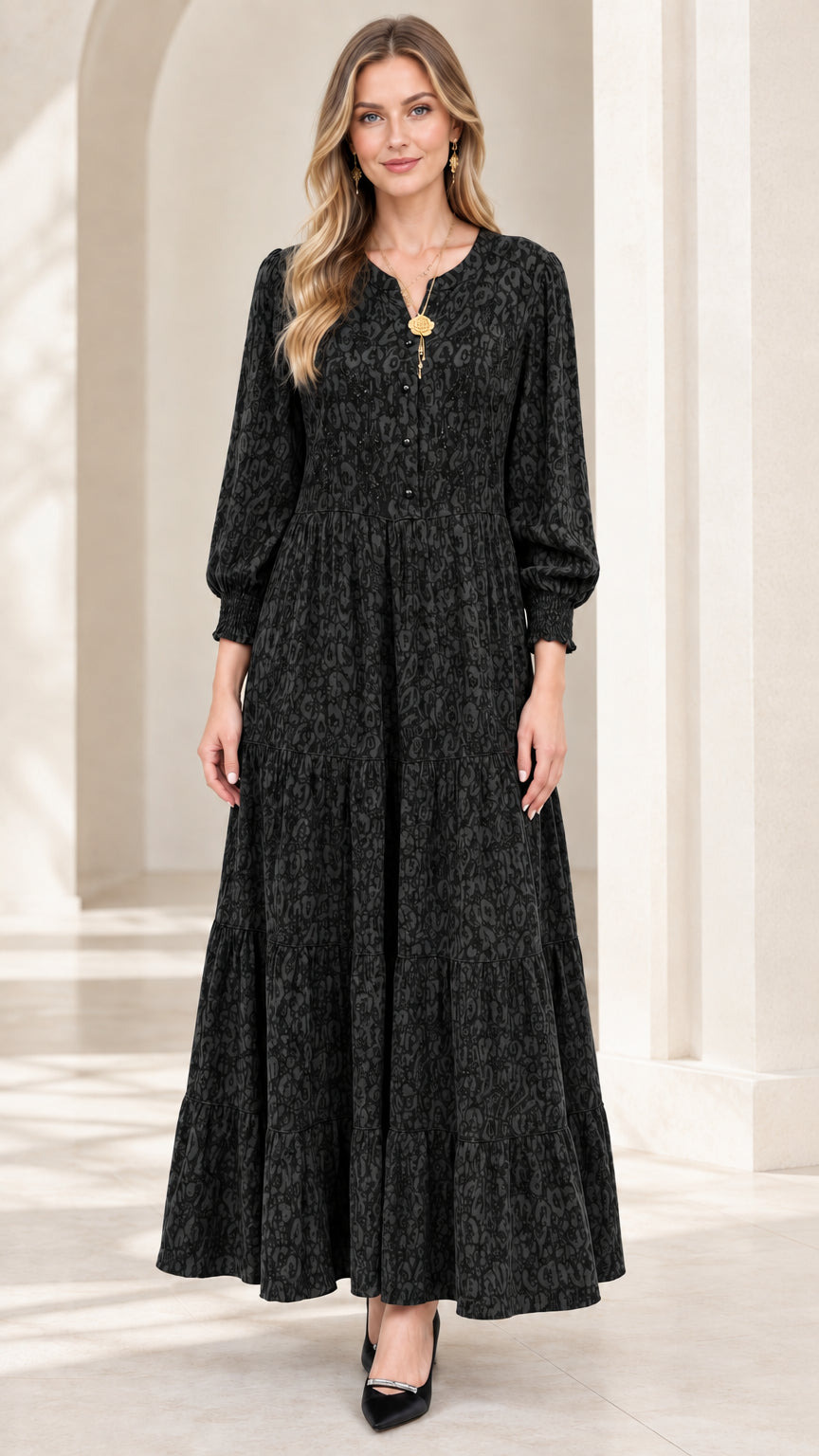 Front view of model wearing black embroidered tiered maxi dress